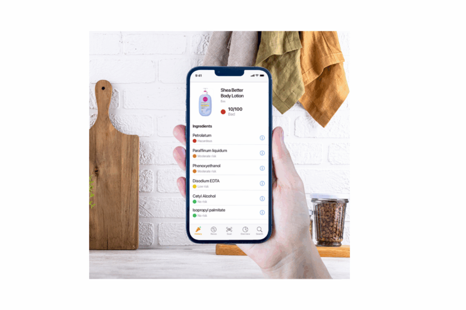 Hand holding a smartphone scanning a body lotion with the Yuka app, showing a low health score for cosmetic ingredients.